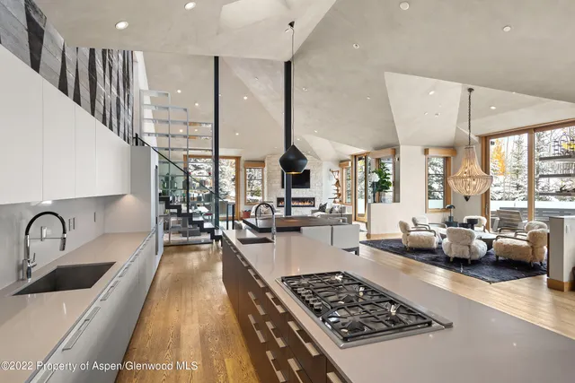 a kitchen with stainless steel appliances a sink a stove and a wooden floor