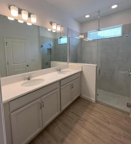 a bathroom with a shower and a sink