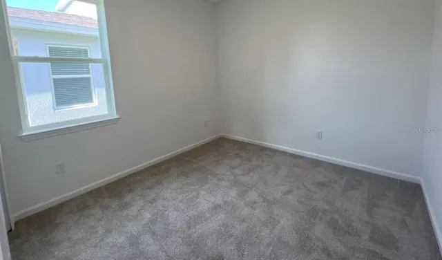 a view of an empty room and entryway