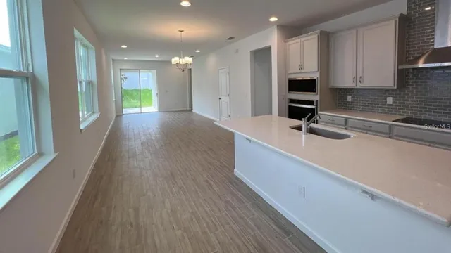 a view of kitchen with sink and refrigerator