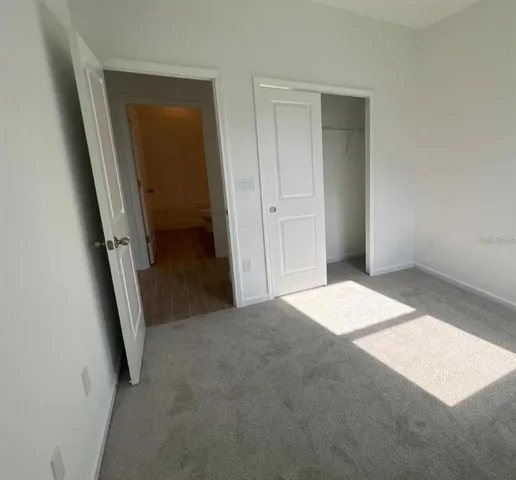 a view of a small space with wooden floor and windows