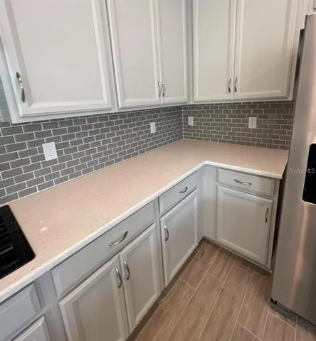 a view of a kitchen with sink and cabinets