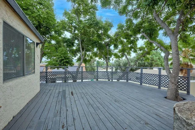 a view of backyard with a deck and wooden floor