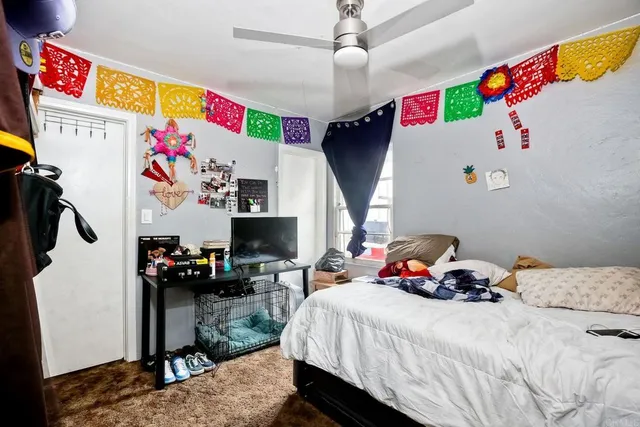 a bedroom with bed and a couch