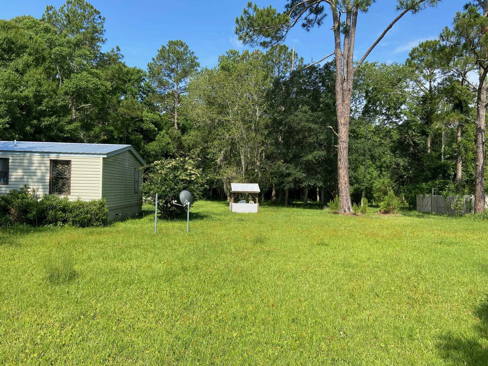 2829 Green Acres Rd Extension St. Augustine, FL 32084 - Photo 3 of 10 a house with a tree in front of it