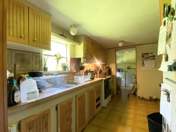 a kitchen with sink cabinets and appliances
