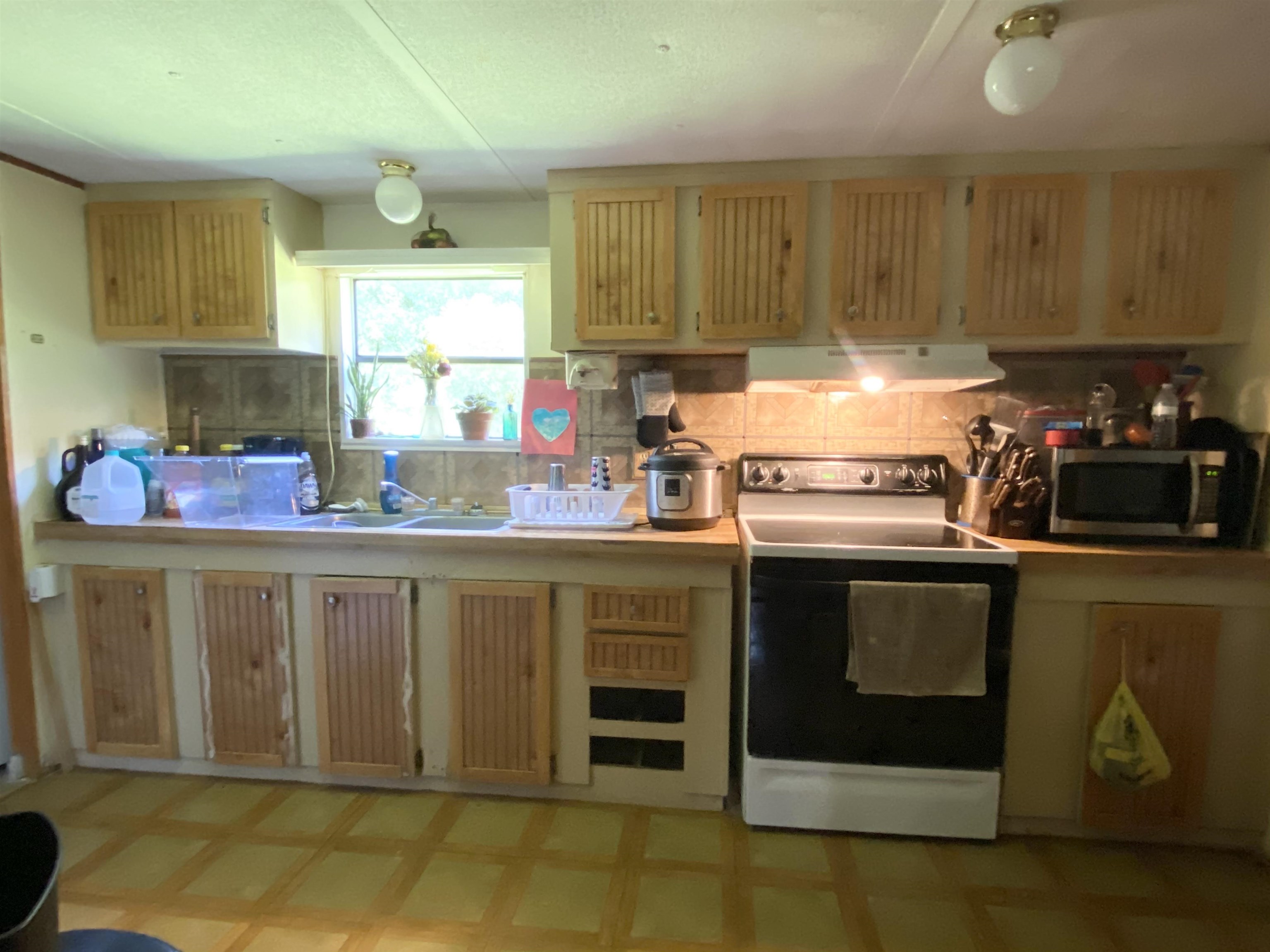 2829 Green Acres Rd Extension St. Augustine, FL 32084 - Photo 6 of 10 a kitchen with stainless steel appliances granite countertop a stove a sink and a microwave