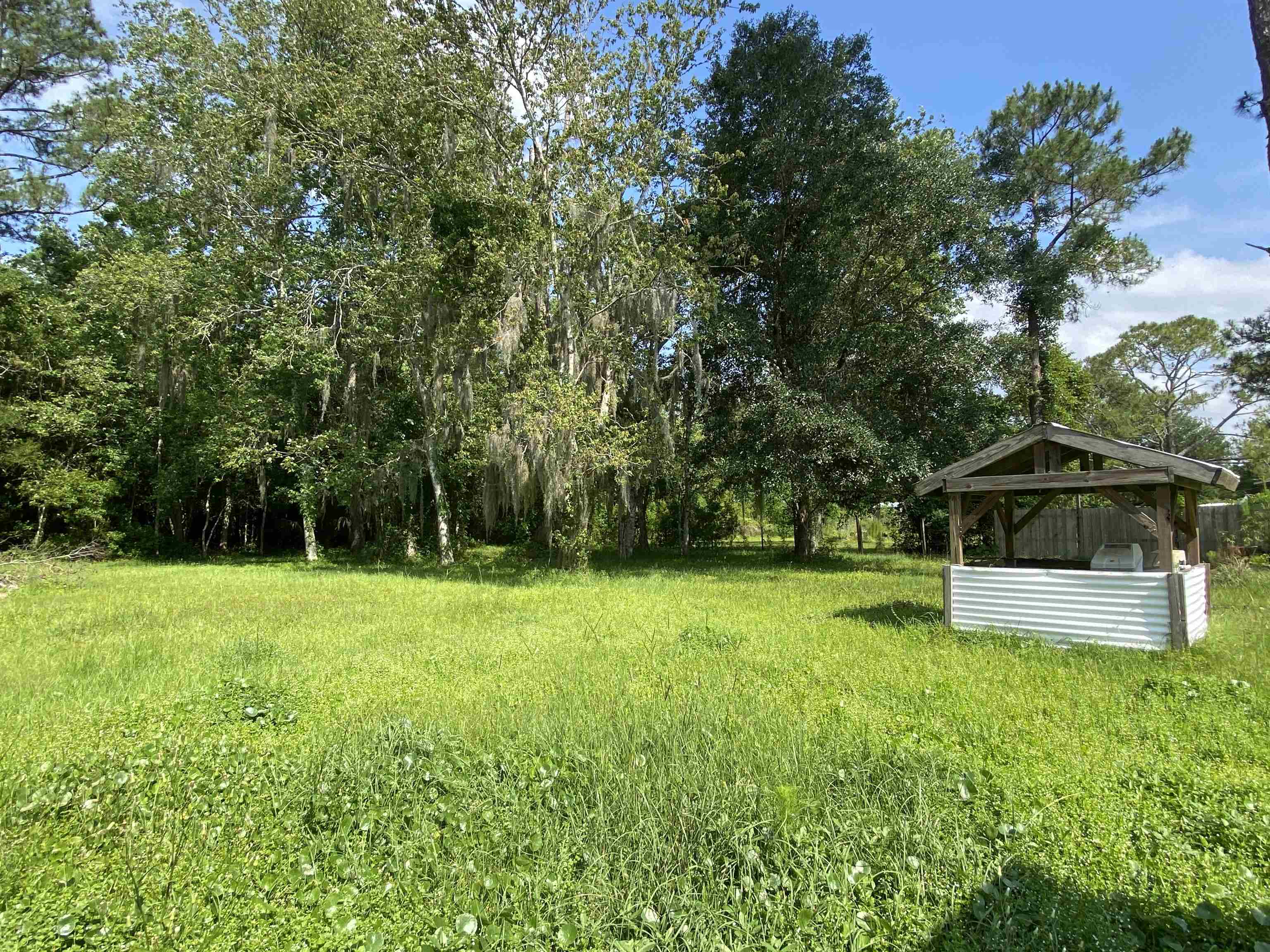 2829 Green Acres Rd Extension St. Augustine, FL 32084 - Photo 9 of 10 a view of a backyard with a garden