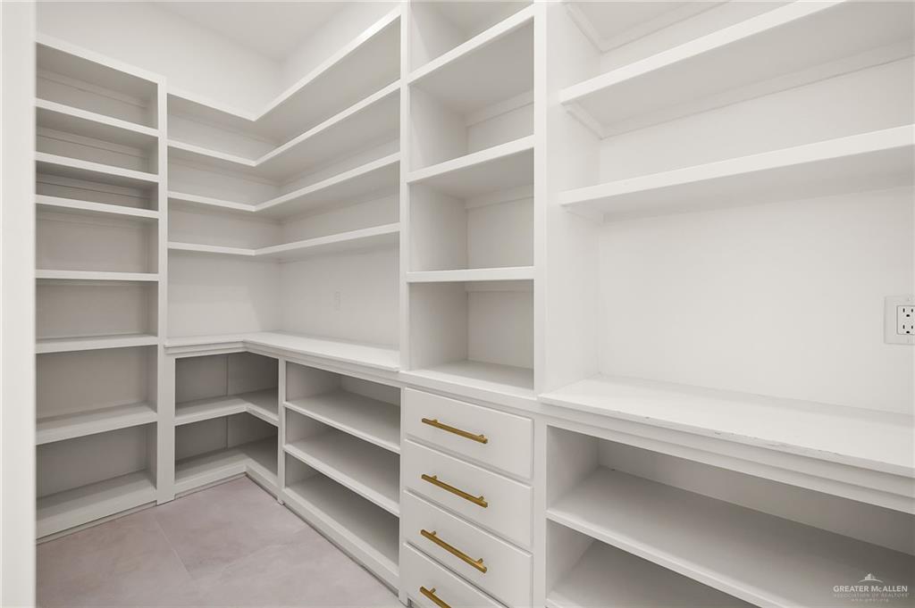 200 Micaela Road, Unit SERVICE Penitas, TX 78576 - Photo 14 of 30 a view of walk in closet with empty racks