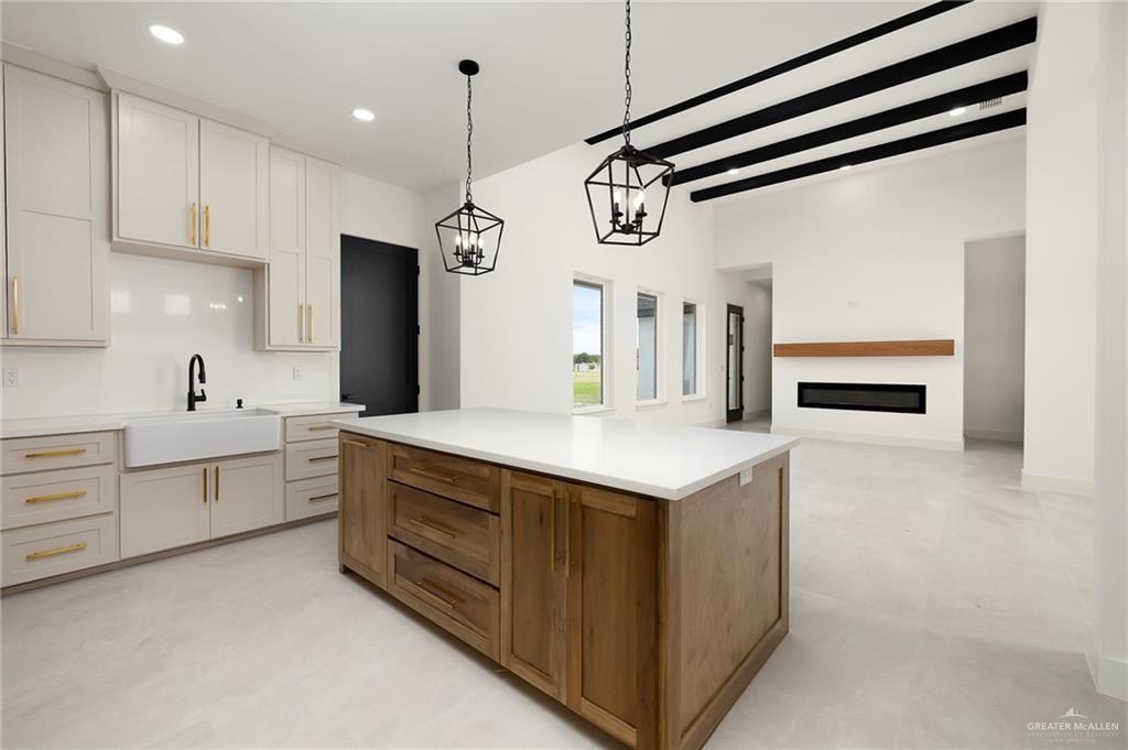 200 Micaela Road, Unit SERVICE Penitas, TX 78576 - Photo 15 of 30 a kitchen with white cabinets and chandelier