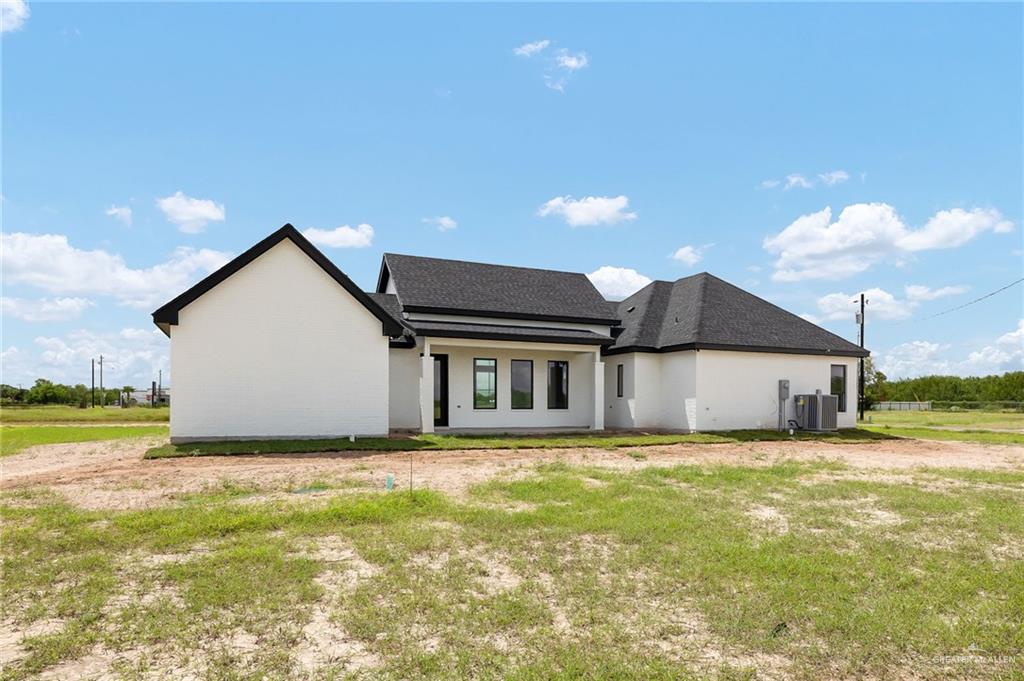 200 Micaela Road, Unit SERVICE Penitas, TX 78576 - Photo 26 of 30 a view of a house with a yard and a garage
