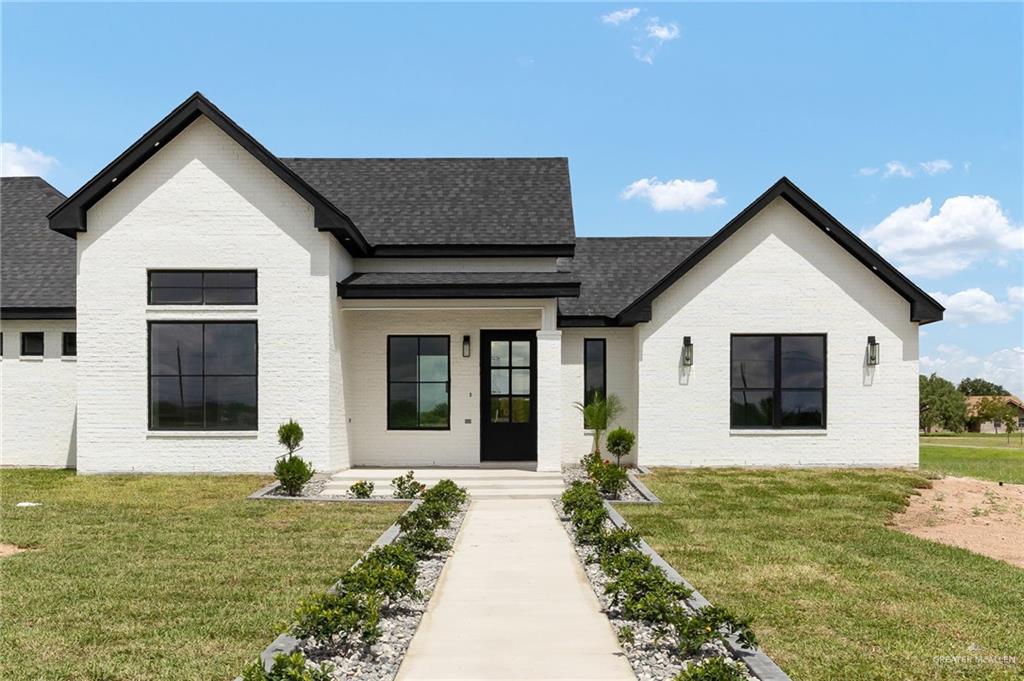 200 Micaela Road, Unit SERVICE Penitas, TX 78576 - Photo 6 of 30 a front view of a house with garden