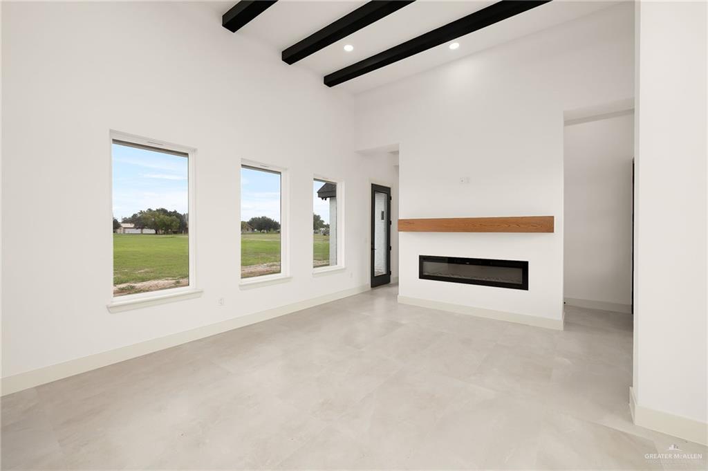 200 Micaela Road, Unit SERVICE Penitas, TX 78576 - Photo 7 of 30 an empty room with windows and fireplace