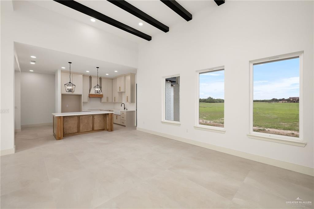 200 Micaela Road, Unit SERVICE Penitas, TX 78576 - Photo 9 of 30 a large white bed in a white room next to a window