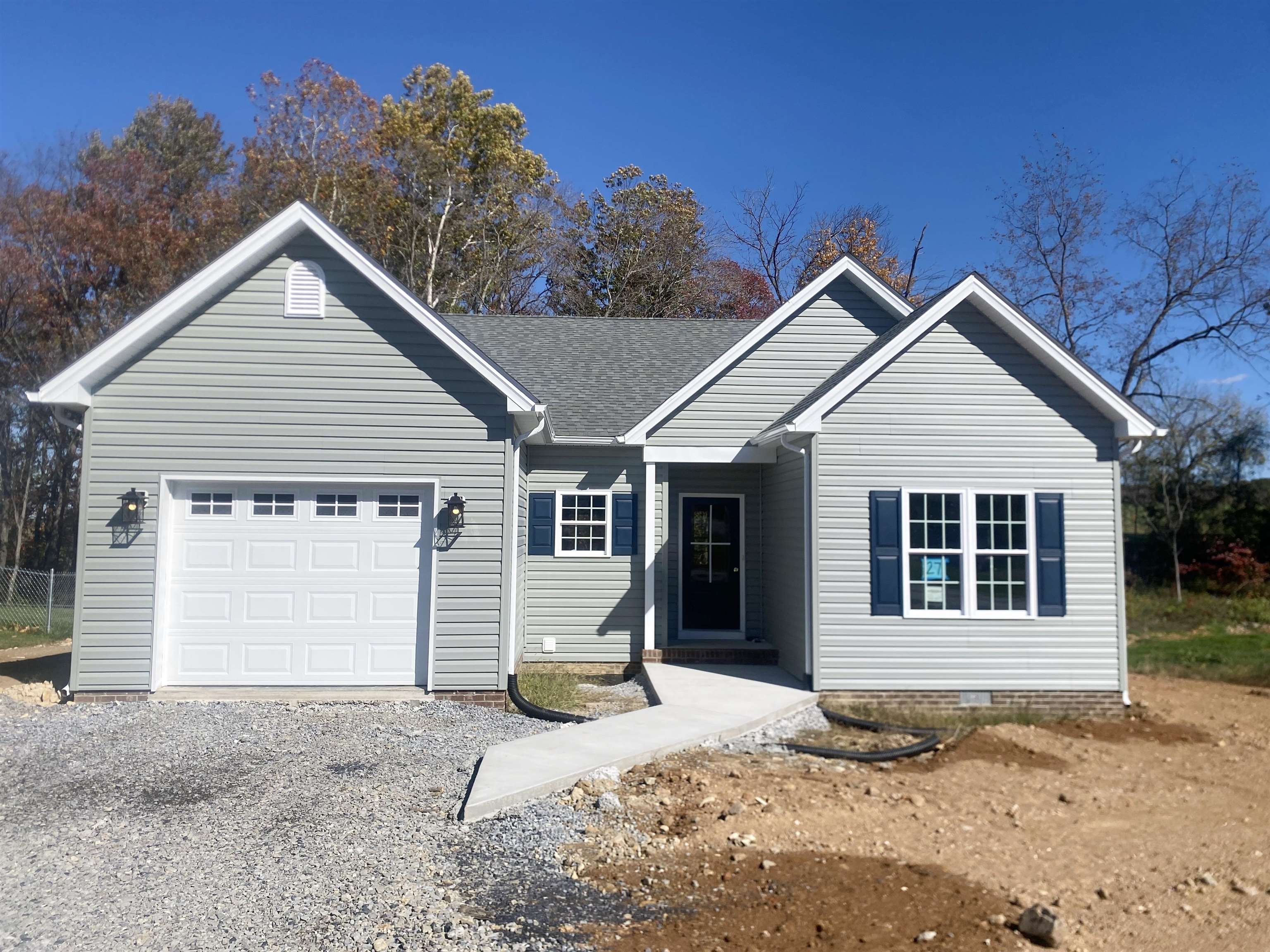 a view of a house with a yard and garage