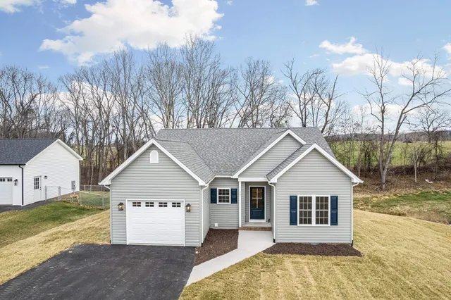 a view of a house with a yard covered in snow