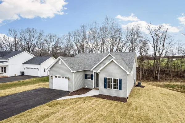 a view of a house with a yard covered in snow