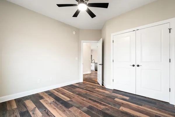 a view of empty room with wooden floor