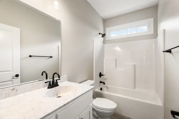 a bathroom with a sink toilet tub and shower
