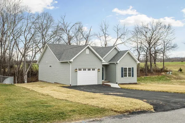 a view of a house with a yard covered in snow