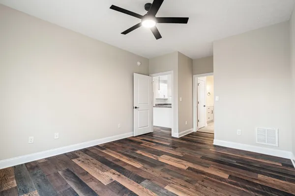 a view of empty room with wooden floor