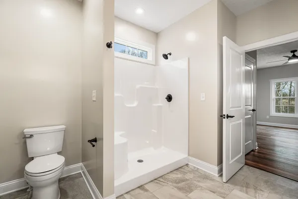 a bathroom with a shower and a toilet