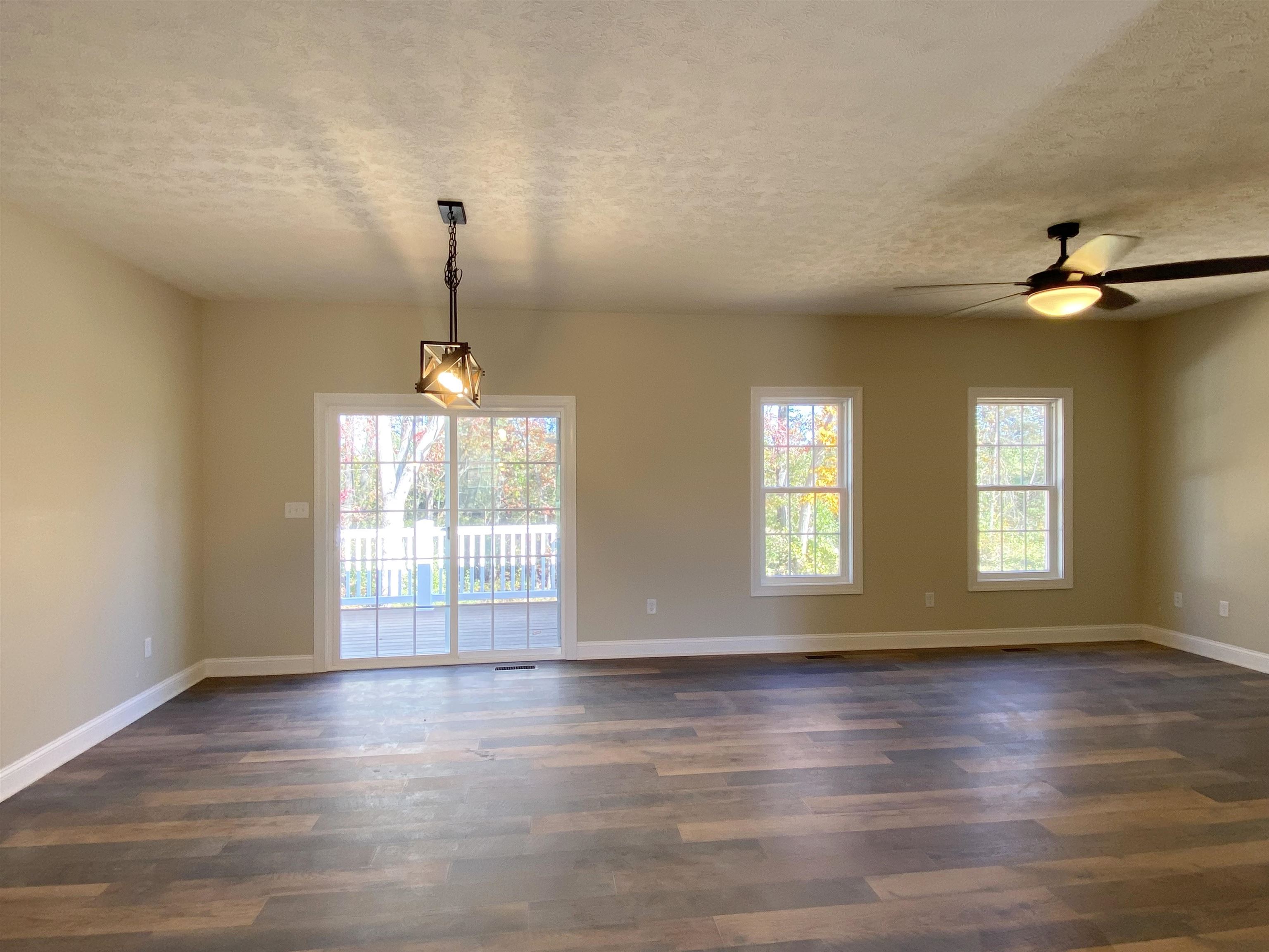 117 Spring Ridge Drive Stuarts Draft, VA 24477 - Photo 4 of 12 an empty room with wooden floor and windows