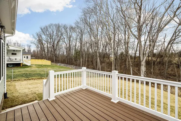 a view of balcony with wooden floor and fence