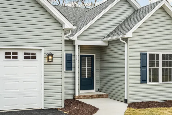 a view of a white house with many windows