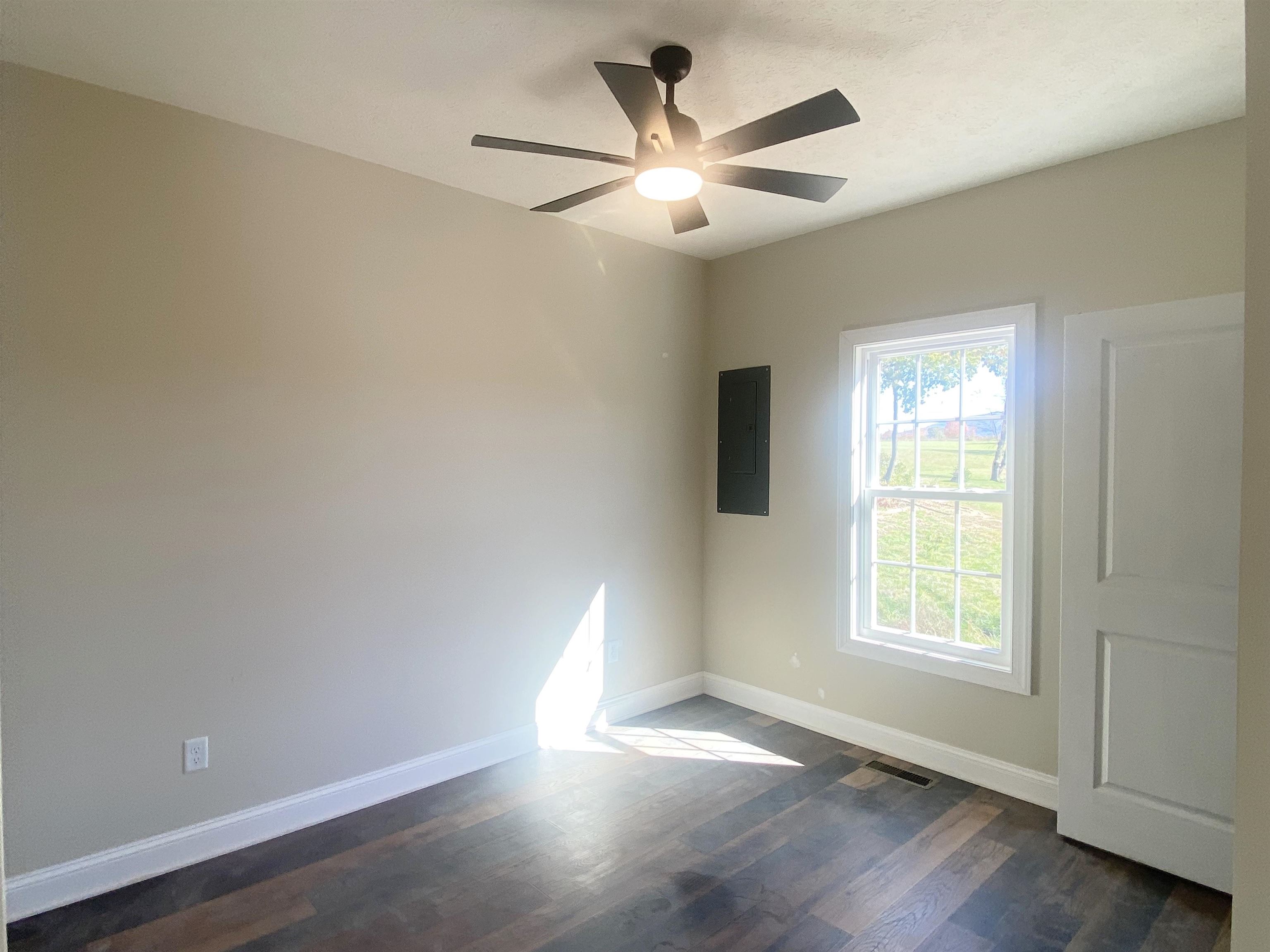 117 Spring Ridge Drive Stuarts Draft, VA 24477 - Photo 7 of 12 a view of an empty room with wooden floor and a window
