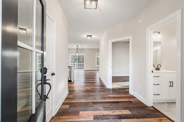a kitchen with stainless steel appliances granite countertop a sink a stove and a wooden floors