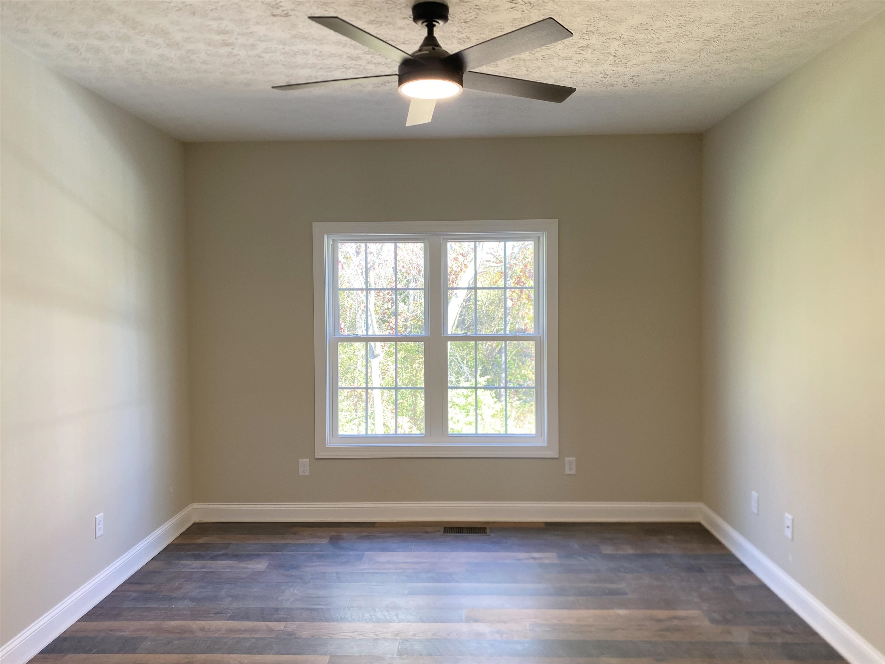 117 Spring Ridge Drive Stuarts Draft, VA 24477 - Photo 9 of 12 an empty room with wooden floor chandelier fan and windows