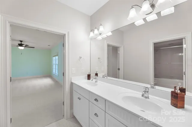 a bathroom with a sink toilet a mirror and shower