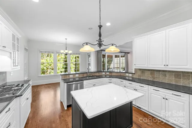 a kitchen with a sink stove and cabinets