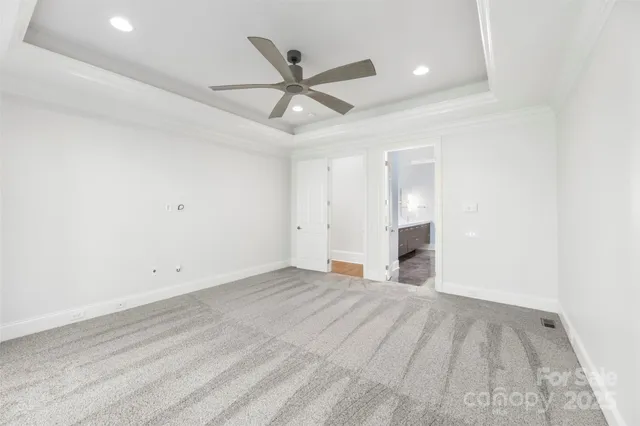 an empty room with ceiling fan and window