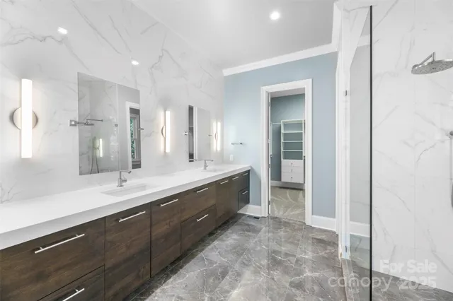 a spacious bathroom with a double vanity sink and a mirror