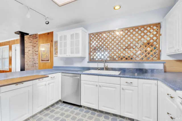 a kitchen with a refrigerator a sink and cabinets