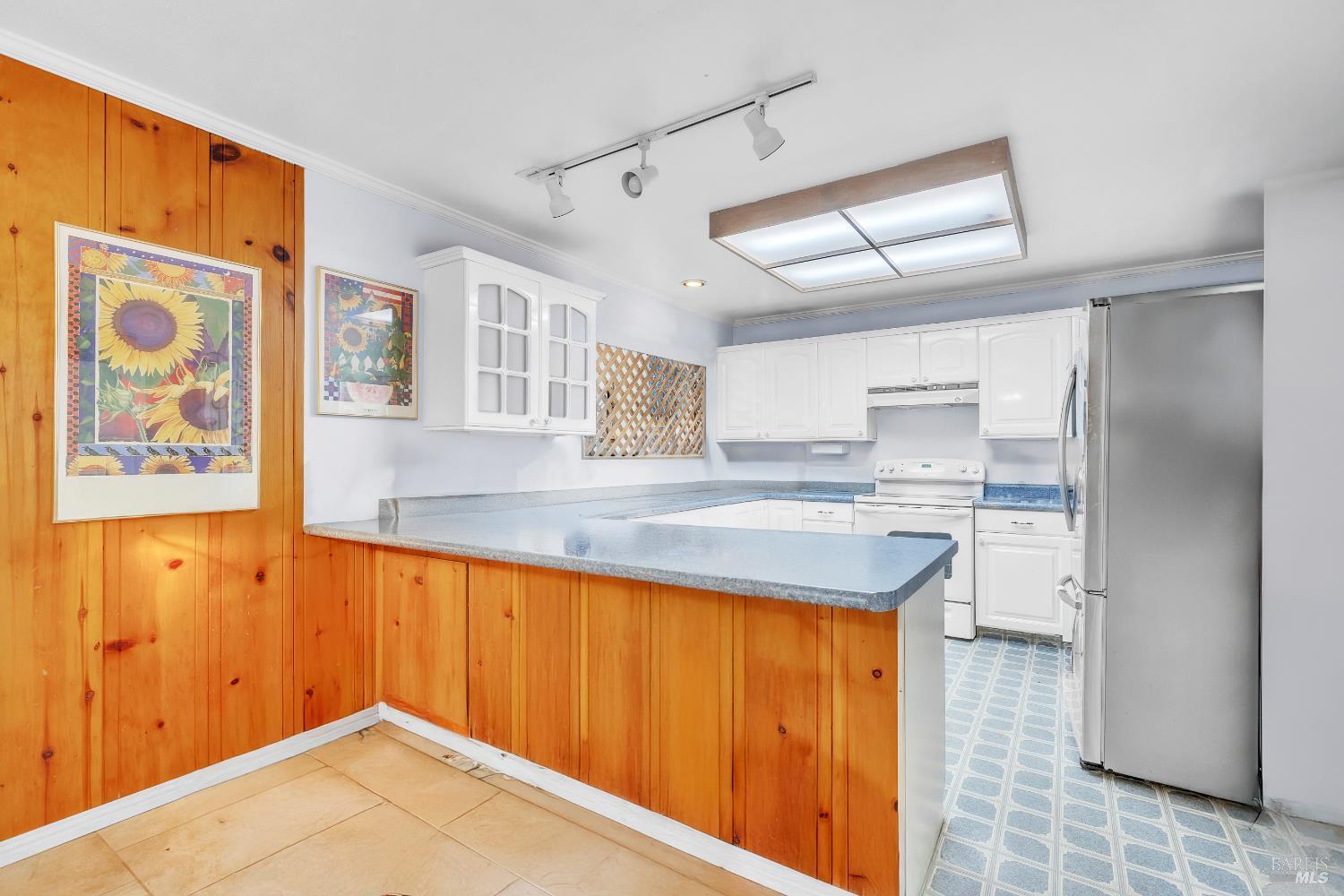 1138 Lokoya Road Napa, CA 94558 - Photo 22 of 35 a kitchen with a refrigerator a sink and cabinets
