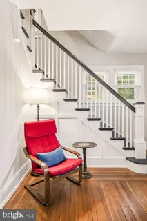 a view of a bedroom with furniture and wooden floor