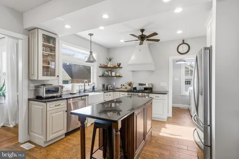 a kitchen with granite countertop a sink and a stove next to a window