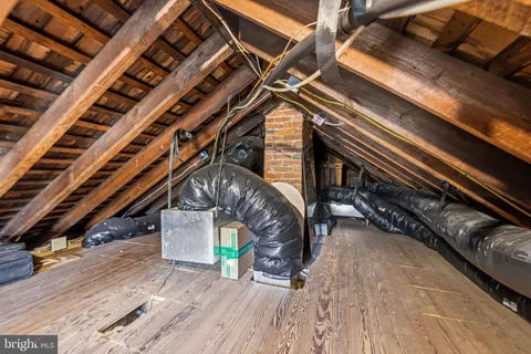 a front view of a house with a yard covered with snow