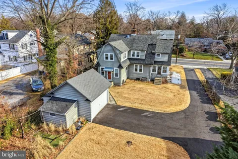 an aerial view of residential houses with city view