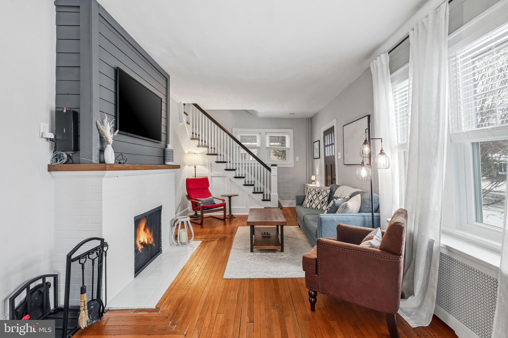 612 Grove Street Haddonfield, NJ 08033 - Photo 6 of 64 a living room with furniture a flat screen tv and a fireplace