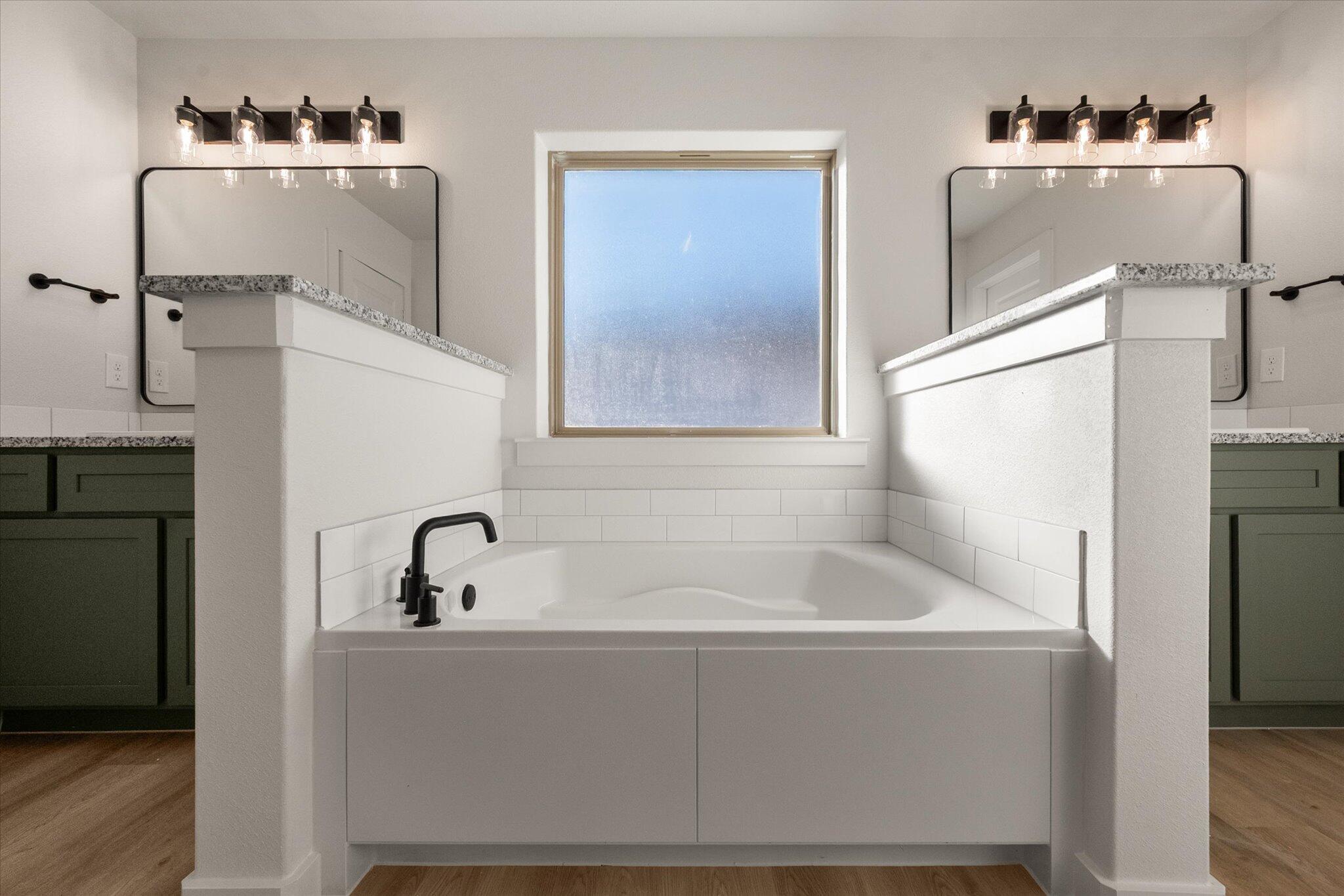 7009 56th Street Lubbock, TX 79407 - Photo 15 of 24 a bathroom with a bathtub and a sink
