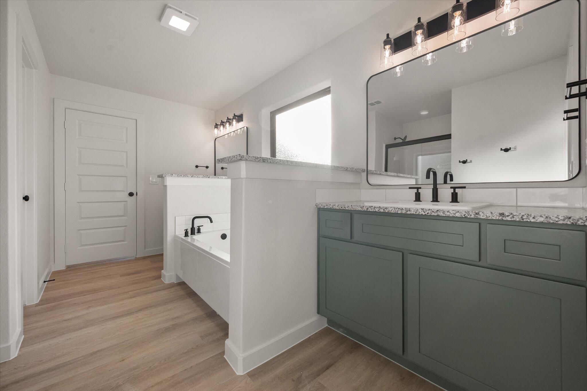 7009 56th Street Lubbock, TX 79407 - Photo 17 of 24 a bathroom with a sink and mirror