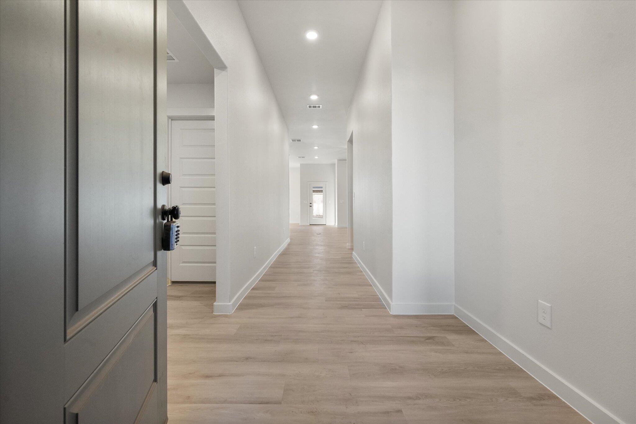 7009 56th Street Lubbock, TX 79407 - Photo 2 of 24 a view of a hallway with wooden floor