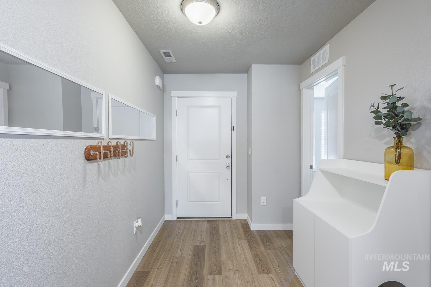 12623 Shadow Peak Street Caldwell, ID 83607 - Photo 6 of 50 Entryway featuring wood-finish flooring, a white paneled door, and recessed lighting
