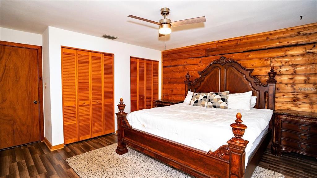 6108 Lynn Road Tampa, FL 33625 - Photo 3 of 6 a bedroom with a bed and wooden floor