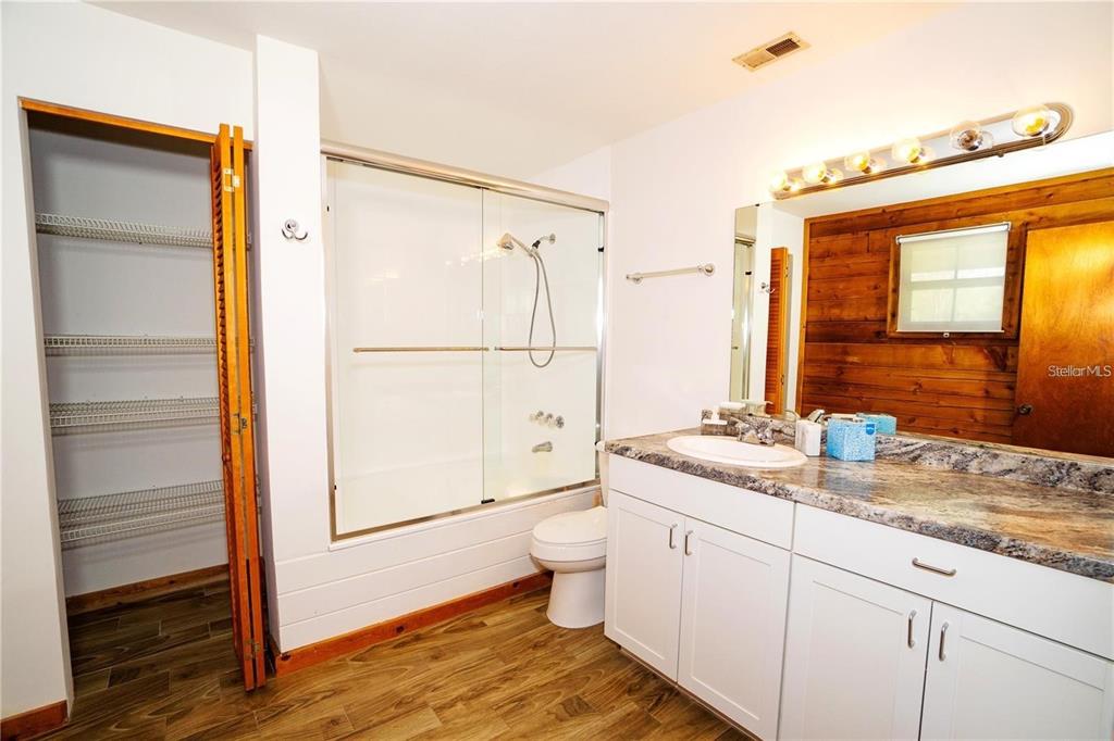 6108 Lynn Road Tampa, FL 33625 - Photo 4 of 6 a bathroom with a granite countertop sink toilet and shower