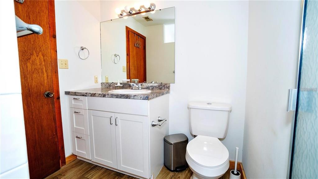 6108 Lynn Road Tampa, FL 33625 - Photo 6 of 6 a bathroom with a granite countertop toilet sink and mirror
